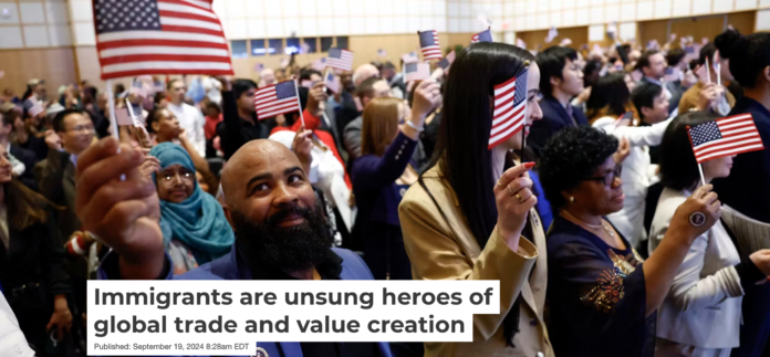 Carmindo Alves Barbosa Amado, originally of Cape Verde, waves the American flag after being sworn in during a naturalization ceremony in Boston in April 2024. Danielle Parhizkaran/The Boston Globe via Getty Images